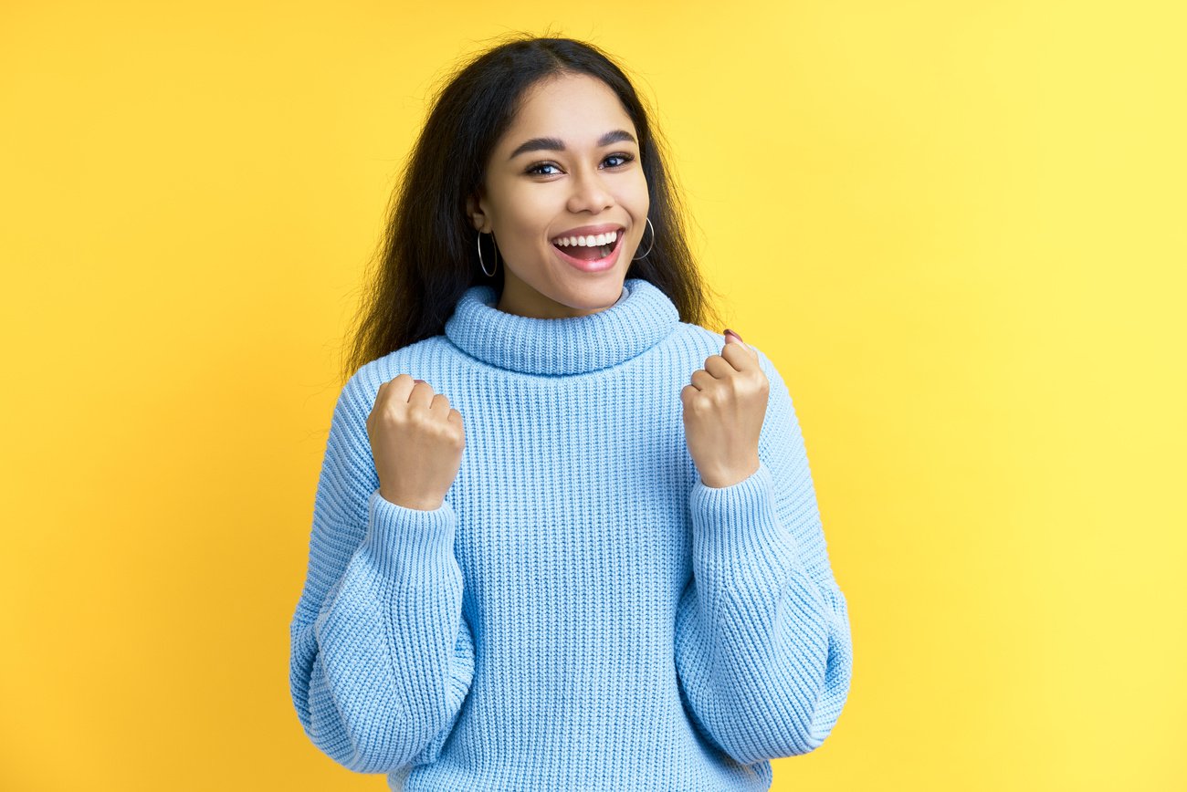 Happy Woman Doing Hand Gesture on Yellow Background